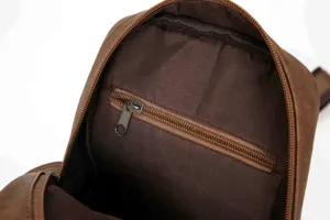 Detailed view of brown men's leather chest bag interior with secure zipper pocket.