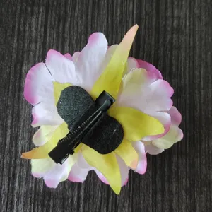 Detailed view of the artificial flower hair clip back side, showing sturdy clip and craft.