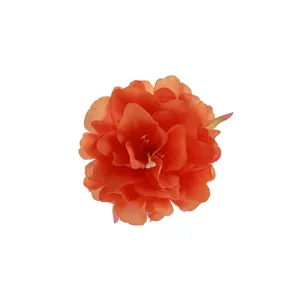 Detailed view of orange polyester artificial peony flower petal texture and vibrant color close up.