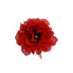 Close-up detail of red artificial fabric peony flower hair clip, vibrant floral hair accessory.