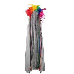 Closeup of colorful faux flowers, black mesh veil, and ribbons on a festival headband.