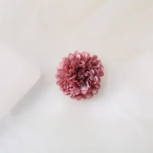 Close up of the 4cm dusty pink fabric flower hair clip detail, elegant bridal photo accessory.