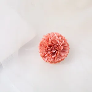 Close-up detail view of the elegant pink fabric flower hair clip showcasing delicate petal texture.