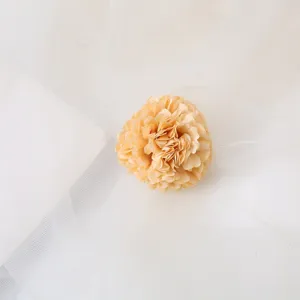 Detailed shot of the elegant champagne fabric artificial flower hair clip, delicate design.