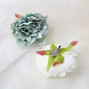 Detailed view of artificial peony flower hair clip and brooch, showing petal and metal clip.