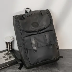 Stylish black casual backpack for men and women, large capacity travel school bag daily.