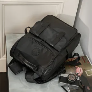 Detailed view of stylish black casual backpack featuring durable fabric and multi-pocket design.
