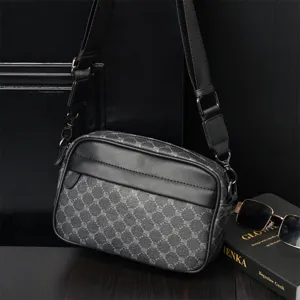 Detailed view of the men's crossbody shoulder bag showing monogram canvas and leather trim.