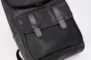 Black nylon casual backpack featuring dual buckle front flap for daily travel school.