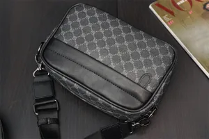 Close-up detail of the men's patterned crossbody bag showing premium leather trim and hardware.
