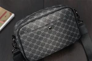 Men's retro monogram crossbody bag with adjustable strap and front pocket storage.