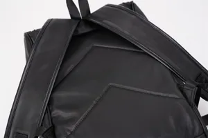 Detail view of the sleek black backpack showing durable shoulder straps and the back panel design.