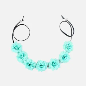 Bohemian floral headband detail featuring seven mint green fabric flowers and adjustable cords.
