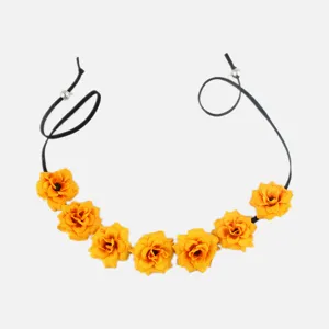 Detailed view of yellow artificial rose hairband with black cord and metal beads.