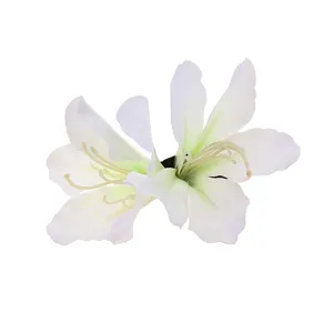Close-up detail of white artificial azalea flower hair clip, delicate fabric floral accessory.