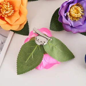 Exquisite detail view of handmade artificial camellia flower hair clip with metal pin back.