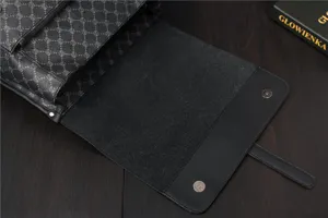Backpack detail view showing black monogram pattern, leather trim and secure magnetic flap clasp.