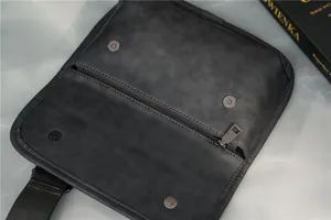 Grey vintage men's messenger bag detail view showing zipper pocket and magnetic snap closure.