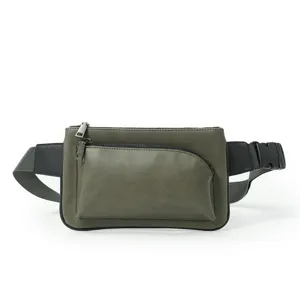 Detailed view of the dark green men's chest bag featuring a front pocket and durable zippers.