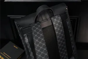Detailed view of black monogram pattern backpack featuring durable leather straps and structured back.