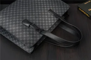 Detailed view of grey PU leather tote bag with black handles and stylish pattern texture.