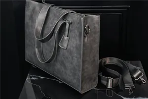 Dark grey PU leather tote bag detail showcasing smooth texture, sturdy handles, and metal hardware.