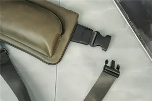 Street fashion men chest bag detail view, PU leather waist bag with durable buckle and strap.