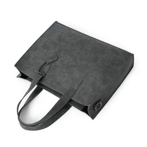 Detail view of dark grey PU leather tote bag, showing structured shape and handles.