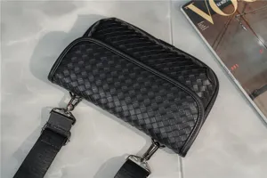 Black woven leather cross-body bag detailed close-up, premium casual shoulder bag for daily use
