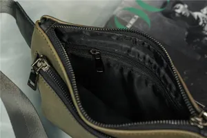 Detail view of stylish men chest bag olive green crossbody bag with zipper pocket and lining.