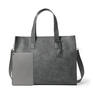 Grey PU leather tote bag detail view showing smooth texture, sturdy handles, and strap.