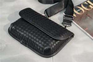 Detail view of a black woven leather crossbody chest bag for men and women, stylish and durable.