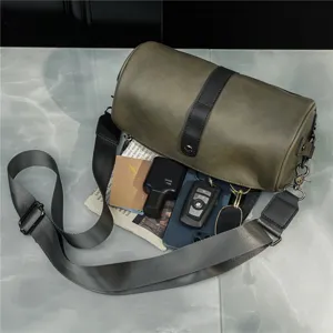 Vintage retro cylinder shoulder bag with wide strap, casual barrel crossbody bag.