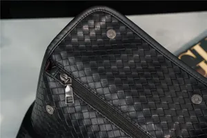 Close-up of black woven leather chest bag, showing exquisite craftsmanship and zipper.