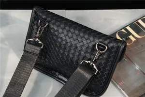 Black woven leather chest bag detail, stylish crossbody shoulder bag with metal hardware.