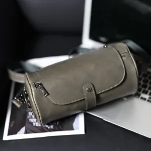 Vintage cylindrical shoulder bag for women and men, casual PU leather crossbody bag fashion.