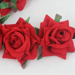 Detail close-up shot of a red velvet rose floral headband hair accessory for wedding party.
