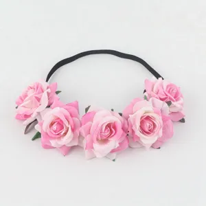 Close-up detail of the pink artificial rose flower headband, featuring soft fabric roses and band.