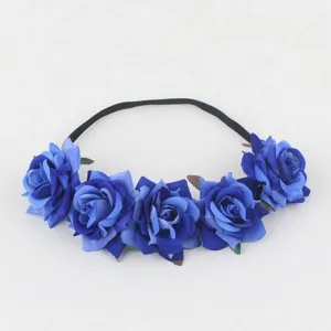 Blue rose floral headband detail showing artificial velvet flowers and black elastic band.