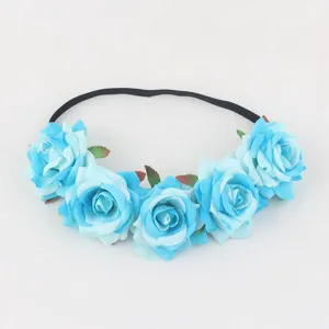 Detailed view of blue artificial rose flower elastic headband for bridal party hair accessory.