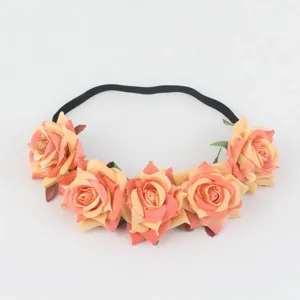 Artificial rose floral headband detail shot showing peach velvet flowers and black elastic band