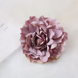 Closeup detail of an artificial dusty purple peony flower head, soft petal texture.