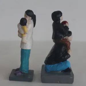 Family figurines detail showing parents and children figures for sandplay therapy props.