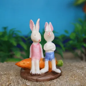 Miniature rabbit carrot figurine detail shot, succulent plant scene decoration accessory.