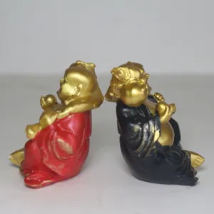 Detail view of mini smiling Maitreya Buddha figurines, red and black resin sand tray toys.