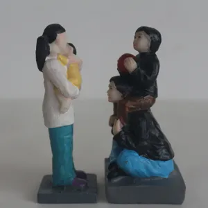 Detailed view of resin family figurines for sandplay therapy and psychological sand tray games.