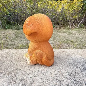 Resin puppy garden ornament detail, cute orange dog figurine for outdoor lawn and patio decor.