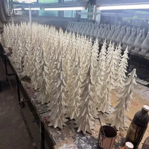 Detailed view of resin Christmas tree craft ornaments, showing fine texture and workshop production.