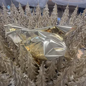 Gold resin Christmas tree figurine detail shot, perfect for holiday home and garden decor display.