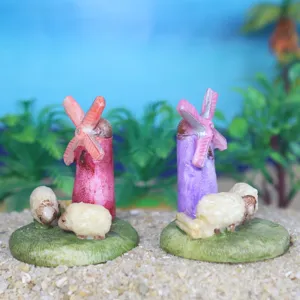 Close-up of miniature windmill and sheep resin ornaments, perfect for succulent plant decor.